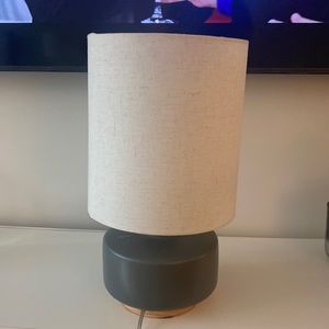 Grey lamp with ivory lamp shade. 17 inches tall and base is 7 inches wide